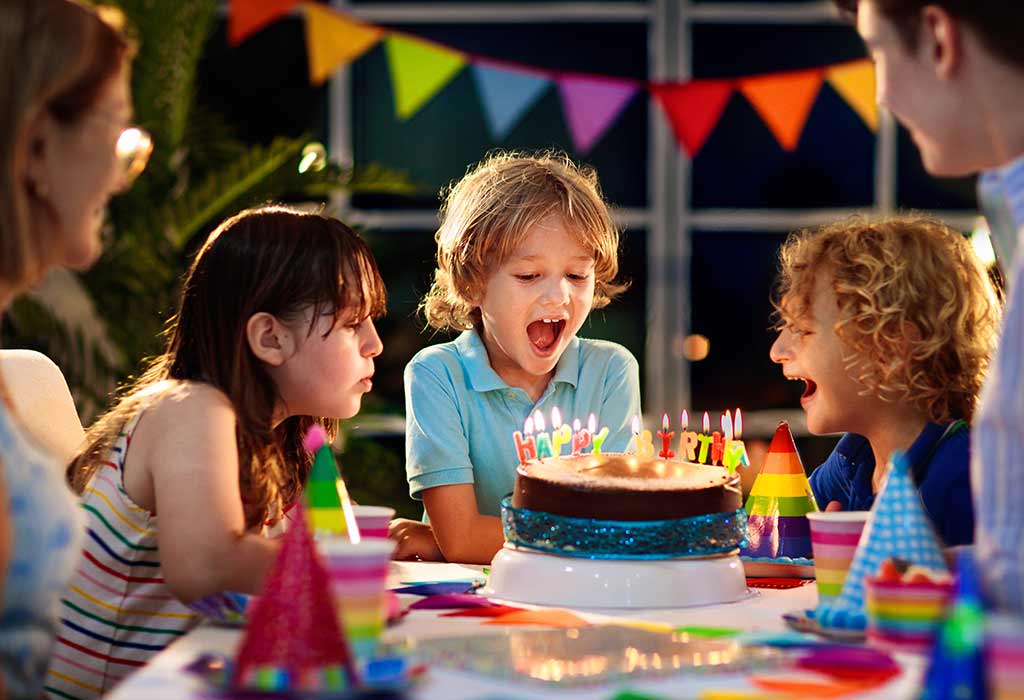 Children celebrating a birthday with a cake