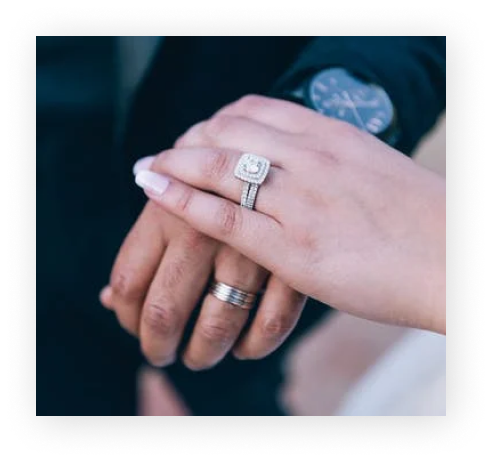 Close-up of hands with engagement rings